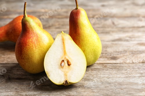 Preview: Ripe pears on wooden table. Space for text