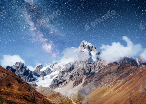 Preview: Fantastic starry sky. Autumn landscape and snow-capped peaks. Ma