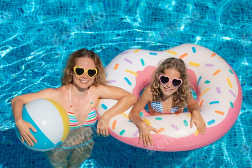 Preview: Happy family playing in outdoor pool