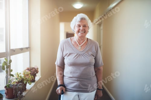 Preview: Smiling Senior Woman Poses in Hallway