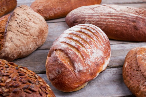 Preview: Fresh crusty bread on wooden background.