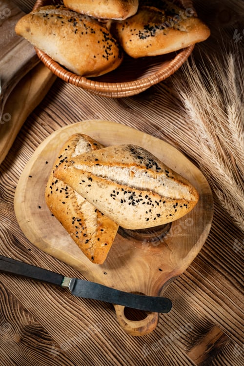 Preview: Fresh bread rolls on a rustic wooden table.