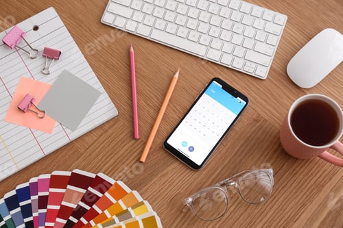 Preview: Smartphone on wooden table, above view. Designer's workplace