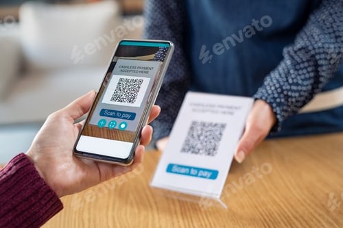 Preview: Customer hand scanning qr code with phone for digital payment