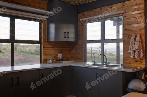 Preview: Interior of empty kitchen in log cabin over green countryside