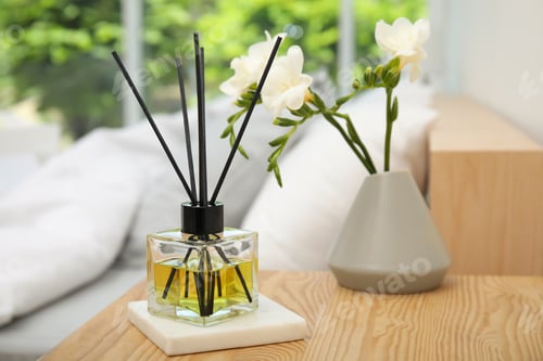 Preview: Reed diffuser and vase with bouquet on wooden nightstand in bedroom