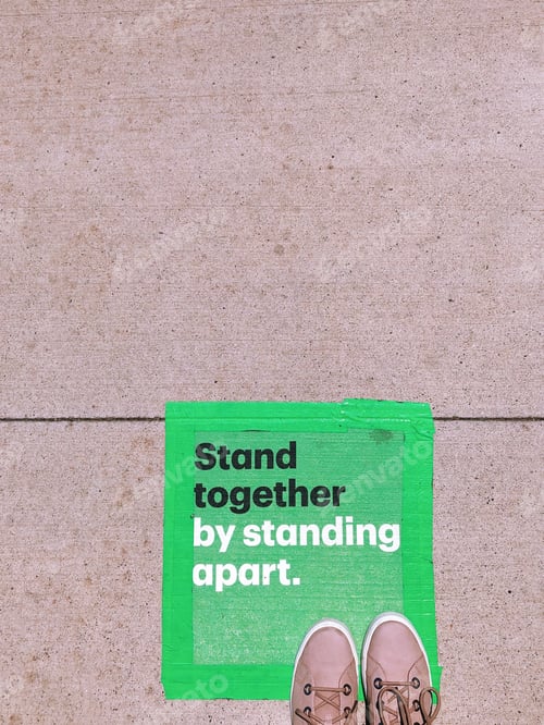 Preview: Marked green squares outside a business to wait for your turn in line keeping physical distancing
