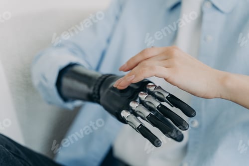 Preview: Hands of handicapped girl setting up her bionic arm and pressing buttons. Robotic bionic prosthesis.