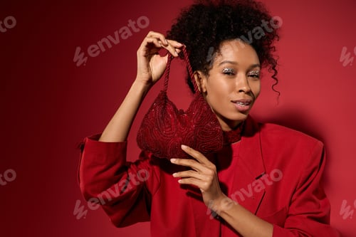 Preview: Stunning young woman showcasing elegant red accessory against vibrant backdrop