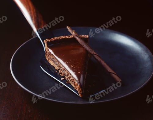 Preview: Slice of chocolate with cake server on plate