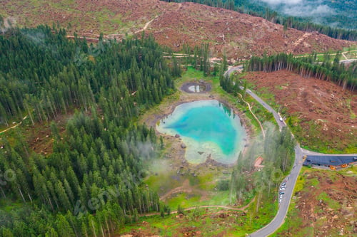 Preview: Aerial view of turquoise blue water of lake Carezza in Alps Dolomites. Lago di Karersee near fir