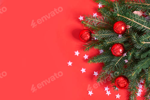 Preview: Closeup of Christmas tree on a red background.