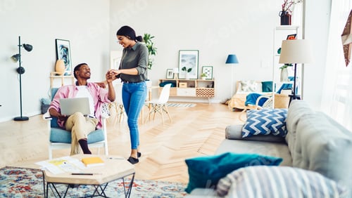 Preview: Carefree woman supporting successful husband doing remote work with startup project