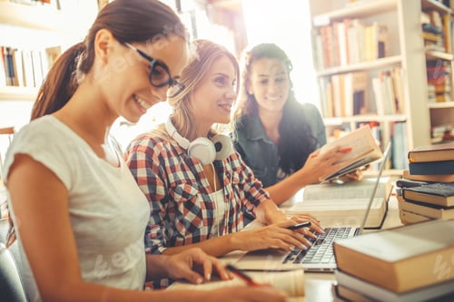 Preview: Group of female students study in the college library.