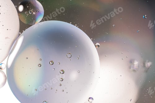 Preview: Oil circles close-up on glass surface under light lighting