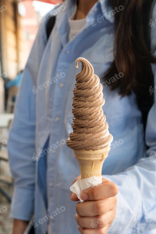 Preview: Woman Holding a Large Swirl Ice Cream Cone
