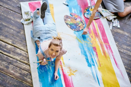 Preview: Happy Caucasian woman with paintbrush posing indoors