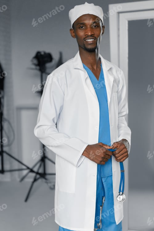 Preview: Handsome Guy Doctor In White Lab Coat With Stethoscope On White Background