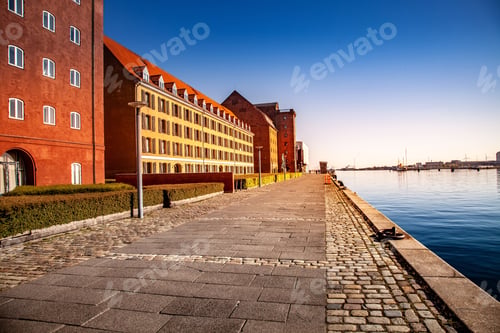 Preview: empty embankment near harbor and buildings at sunny day, copenhagen, denmark