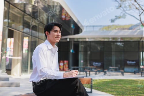 Preview: Young student planning future outdoors on campus