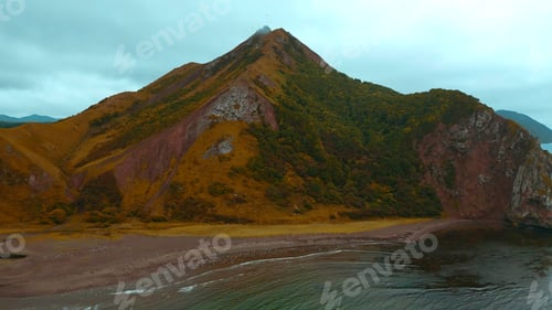 Preview: Top view of wild coast with rocky mountains. Clip. Flock of seagulls on ocean shore on backdrop of