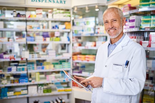 Preview: Portrait of a mature pharmacist using a digital tablet while working in a chemist