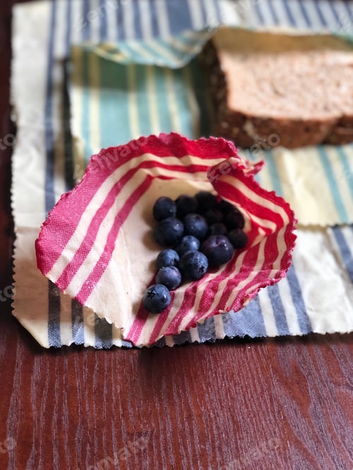 Preview: Lunch of blueberries and sandwich wrapped up in reusable and sustainable eco friendly wax wraps