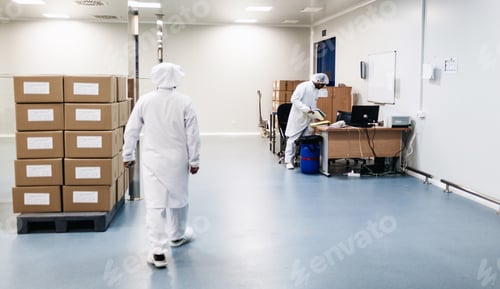 Preview: Two men working in a warehouse wearing white aprons