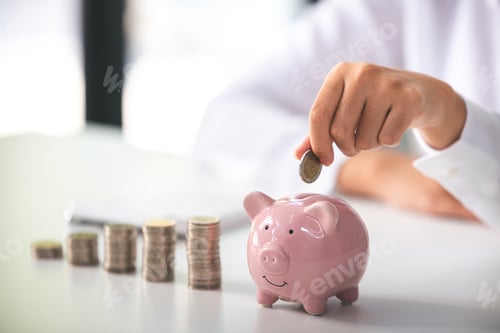 Preview: business woman holding a coin in a piggy bank On a table with sunlight. Money Saving Ideas for Finan