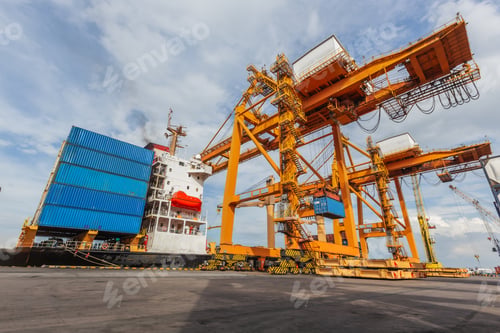 Preview: Massive yellow gantry cranes stand beside a cargo ship loaded