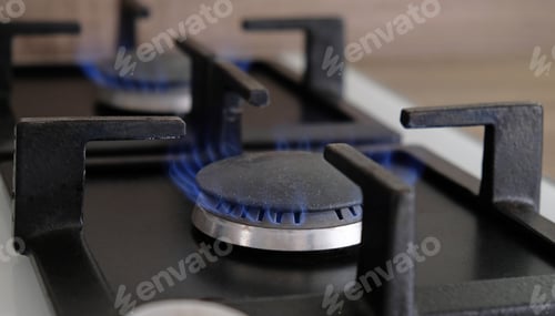 Preview: Close-up blue flames of fire on a gas burner in the kitchen for cooking. Gas flame in a gas boiler.