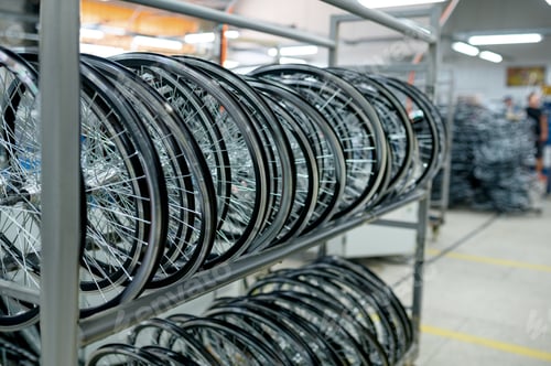 Preview: Row of new aluminum bicycle wheels on the shelf