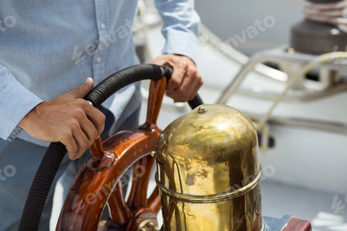 Preview: Man steering sailboat