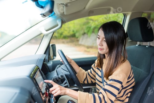 Preview: Woman driving a car and touch on GPS