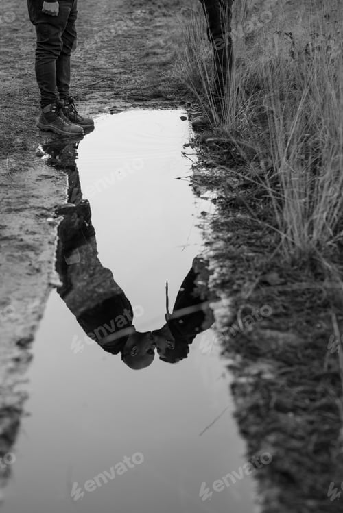 Preview: Men kissing near dog and water puddle