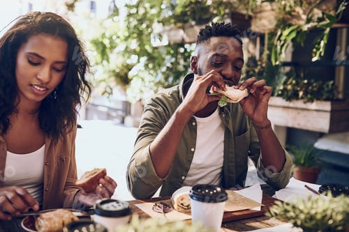 Preview: Cant say no to a good sandwich. Cropped shot of a happy young couple out for lunch at a cafe.