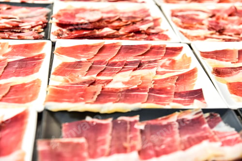 Preview: Detail several dishes of cut serrano ham during an event.