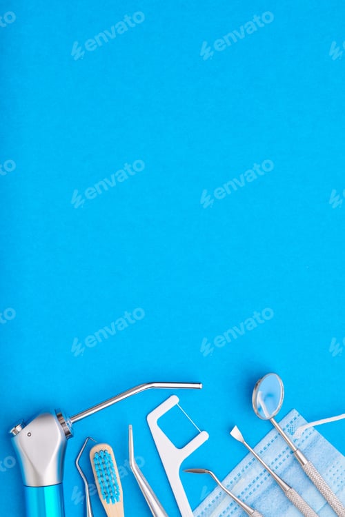 Preview: Dentist tools over blue background top view