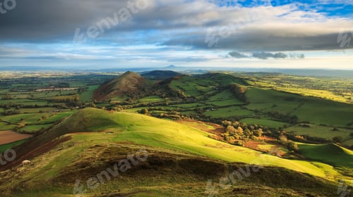 Preview: The northern face of Caer Caradoc, the morning light casts a warm glow on the landscape