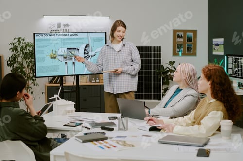 Preview: Woman Explaining Wind Turbines in Office Setting