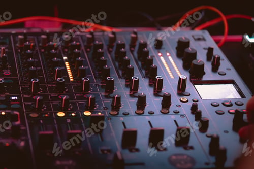 Preview: DJ mixing electronic music in dark club
.dng