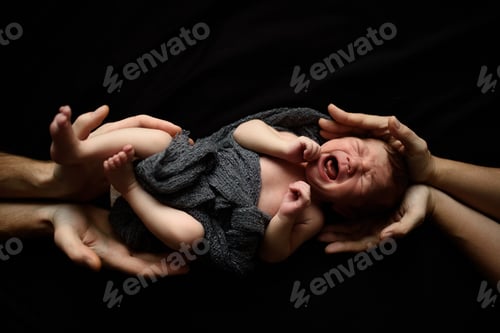 Preview: Little newborn boy on a black background.