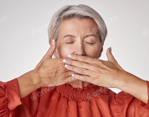 Preview: One mature caucasian woman isolated against a grey copyspace background in a studio with her hands