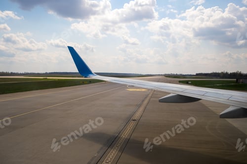 Preview: View of jet airplane wing taxiing runway after landing at airport