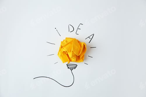 Preview: Composition with crumpled paper as lamp bulb and word IDEA on white background