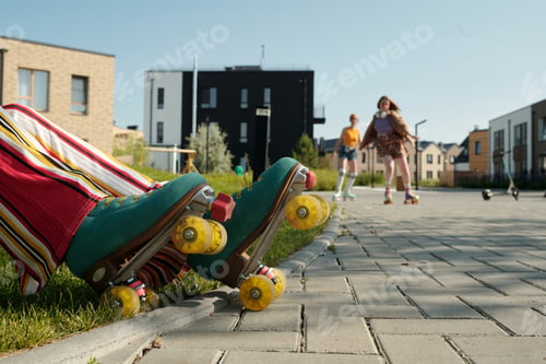 Preview: Lower part of legs of young active female teenager i roller skaters