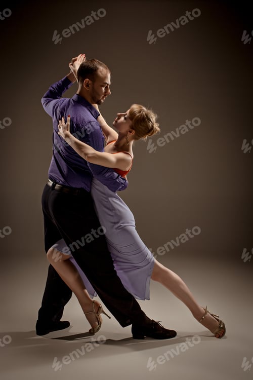 Preview: A Man And A Woman Dancing Argentinian Tango On Gray Studio Background