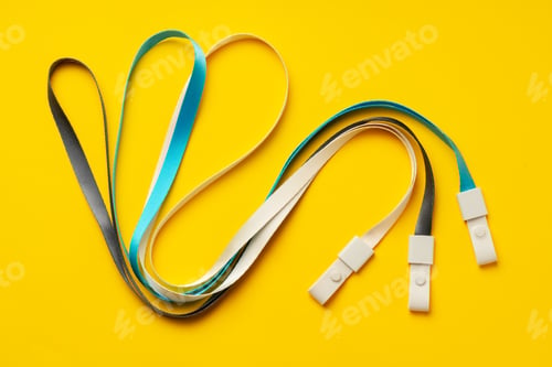 Preview: Badge strings on yellow background close up