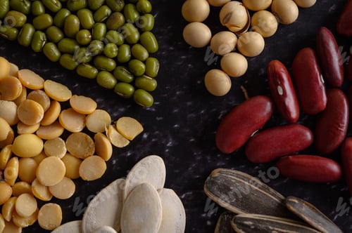 Preview: Legumes arranged in a circle on the black cement floor.