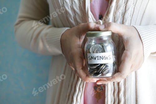 Preview: Savings Jar Held by Adult Inside Home